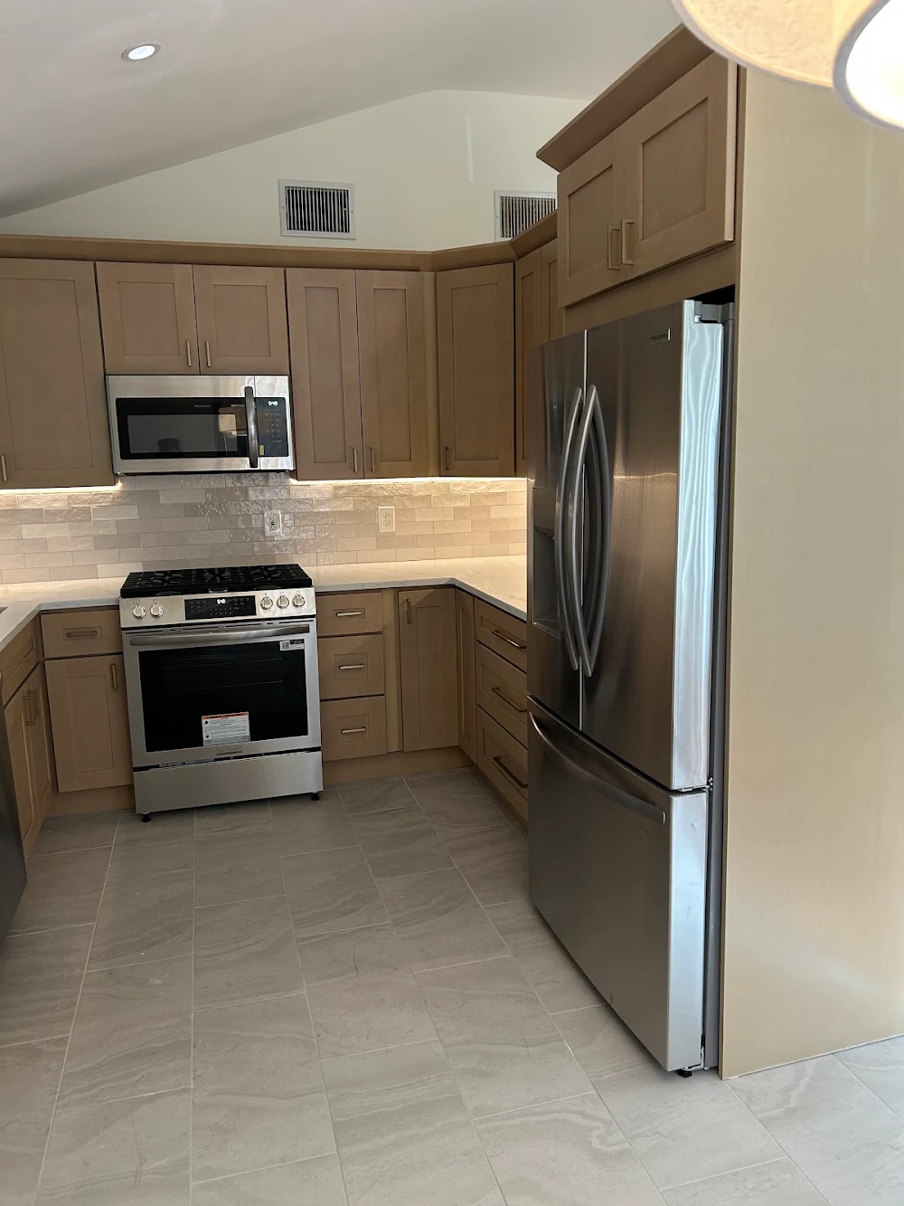 Vaulted-ceiling kitchen and light-wood cabinets in the New City remodel