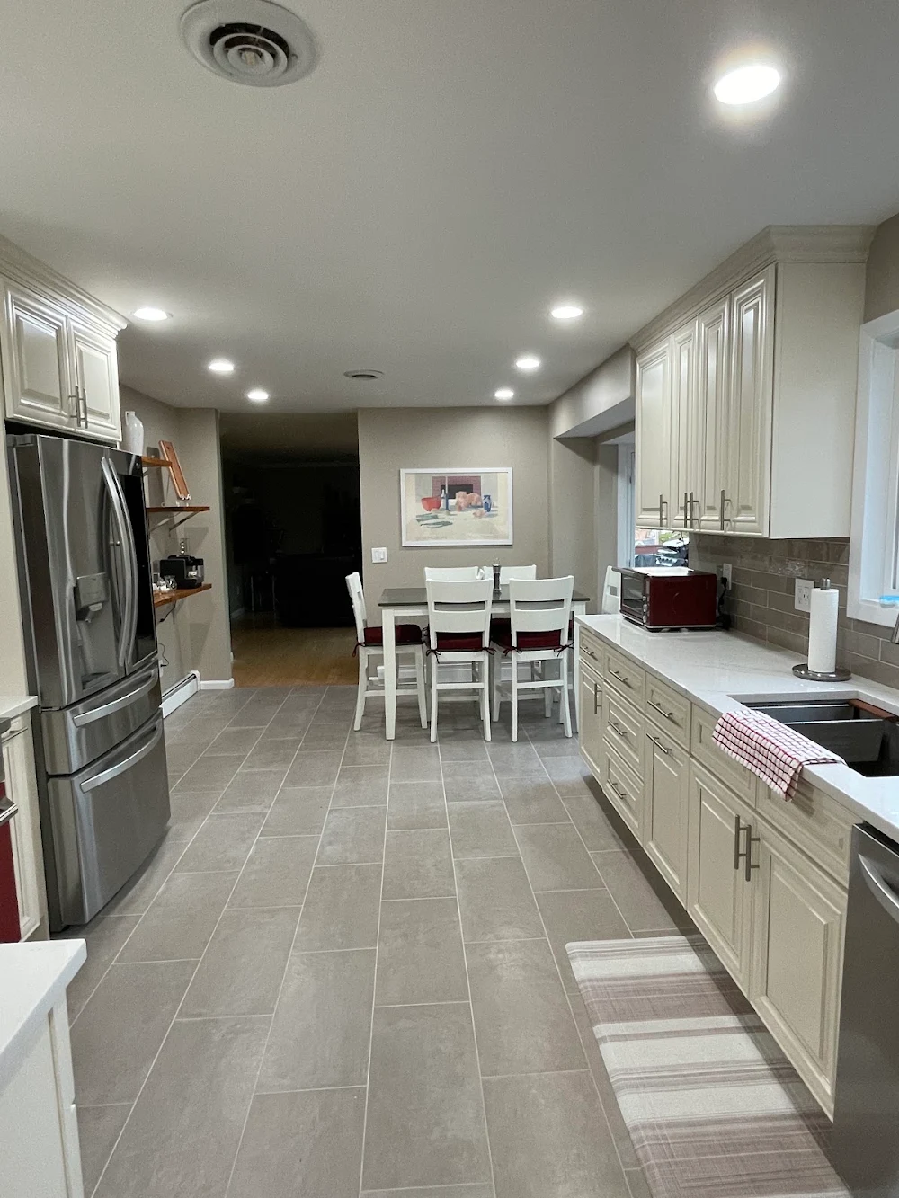 White cabinetry and tiled flooring in the completed Nanuet kitchen