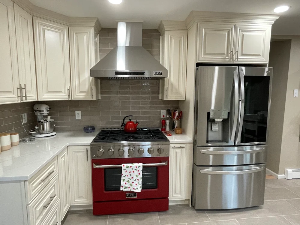 Completed white kitchen remodel in Nanuet, NY with a red range