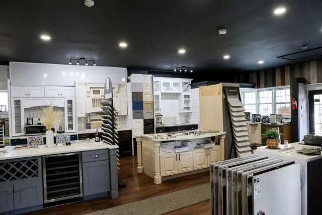 Wide showroom view with cabinet islands and wall displays