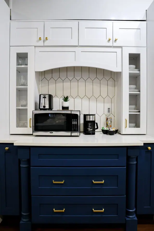 Navy vanity display with brass hardware and framed mirror