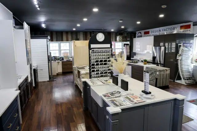 Long showroom aisle with kitchen islands and cabinet displays