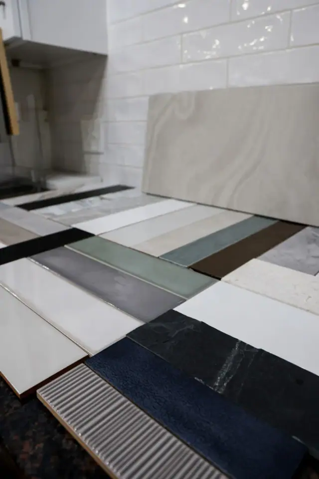 Countertop and tile sample boards arranged on a work surface