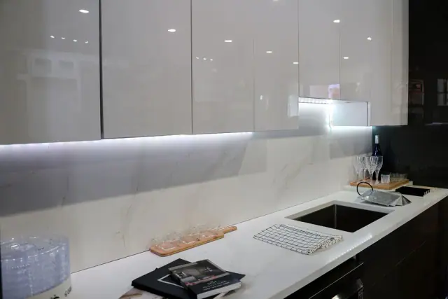 Glossy gray cabinet wall with under-cabinet lighting