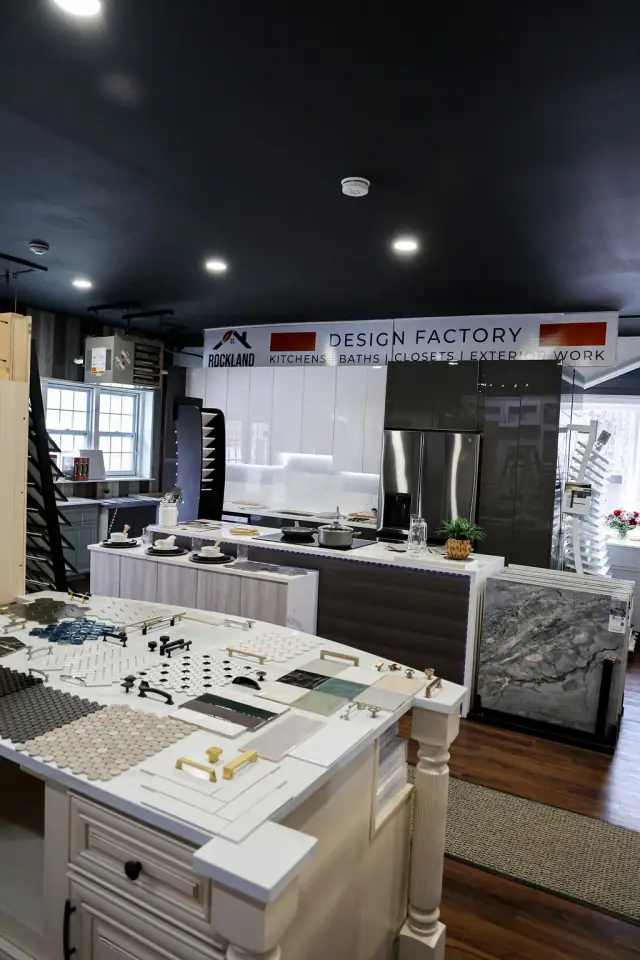 Kitchen display aisle beneath a dark showroom ceiling