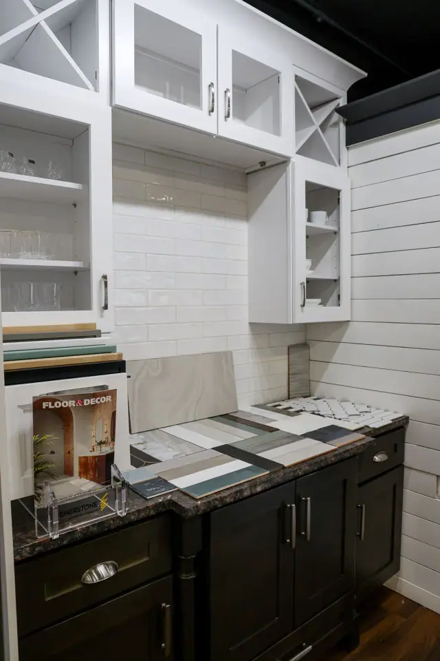 White glass-front cabinets above a dark countertop