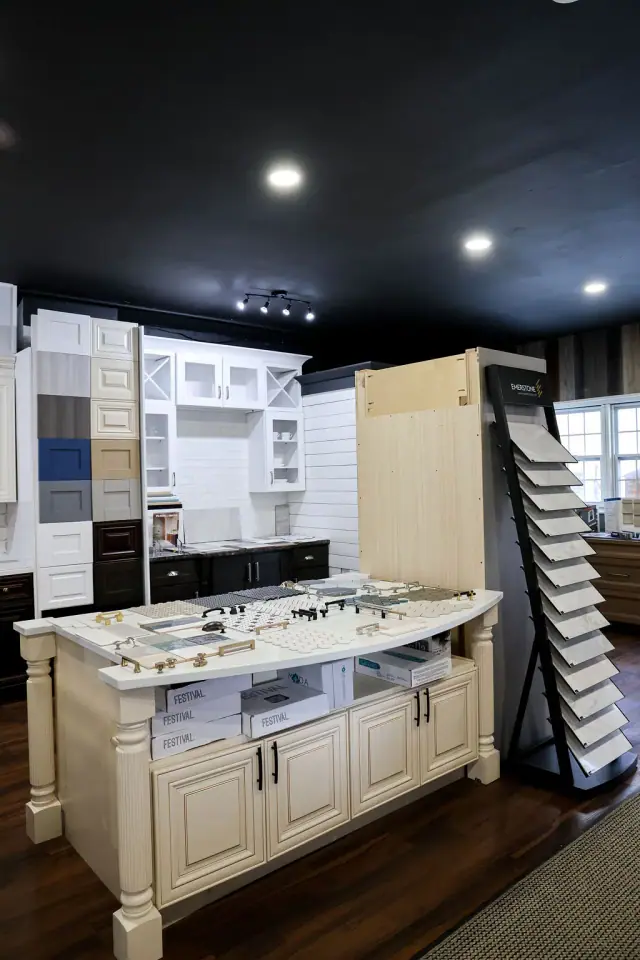 White kitchen island display with sample racks nearby