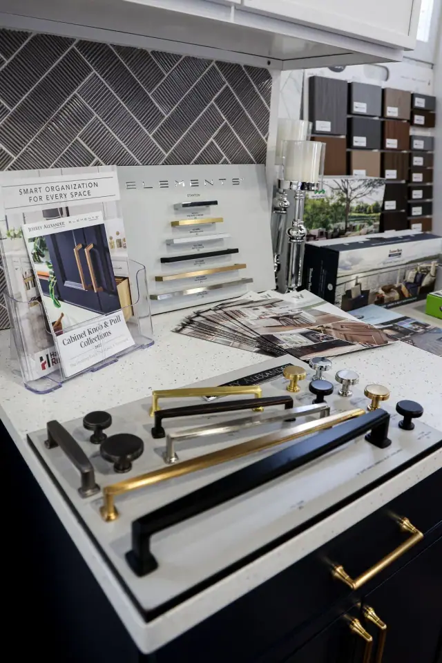 Hardware and finish samples spread across a showroom table