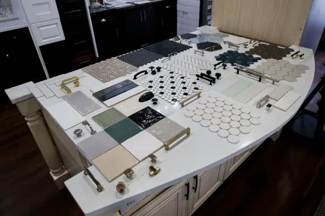 Cabinet finish boards arranged across a large worktable