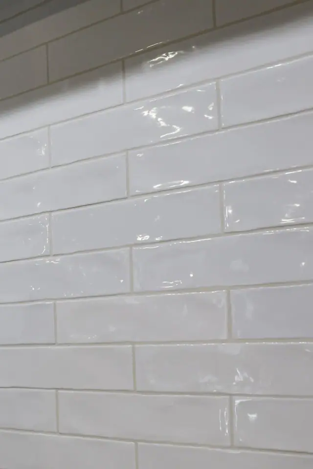 White textured tile backsplash shown at close range