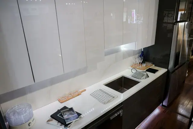 Gray cabinet run with sink and under-cabinet lighting