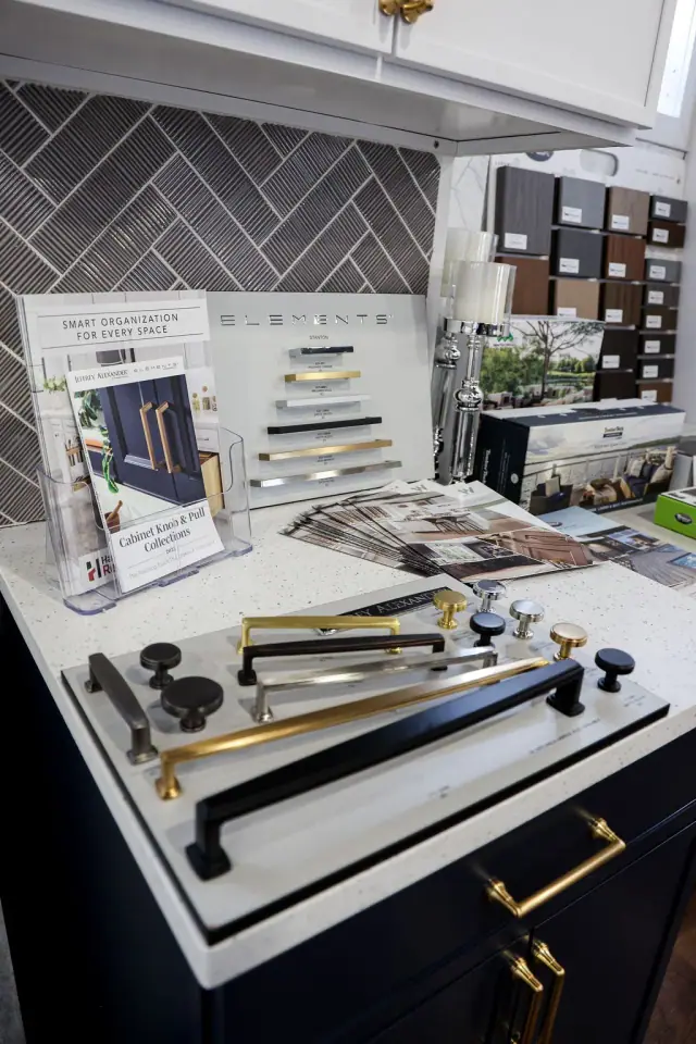 Hardware, tile, and finish samples grouped on a table
