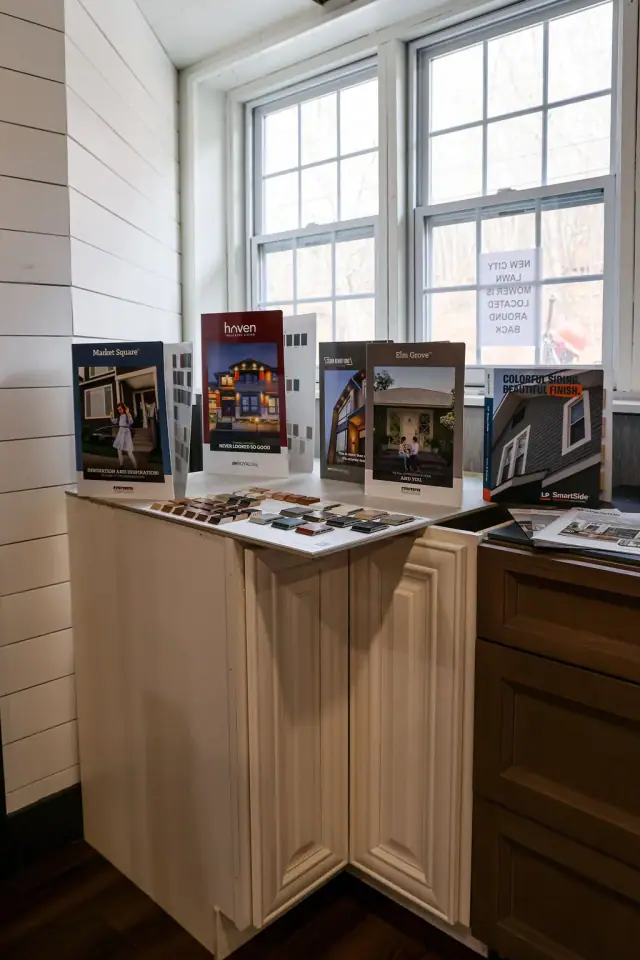 Wood cabinet sample station beside a bright showroom window