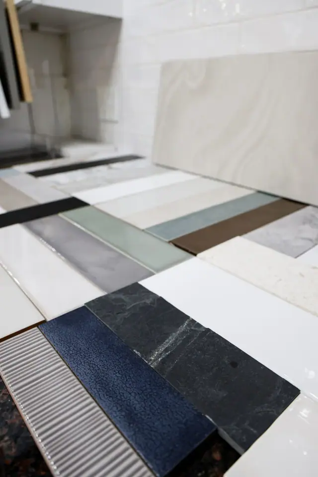 Mixed countertop sample boards spread across a table