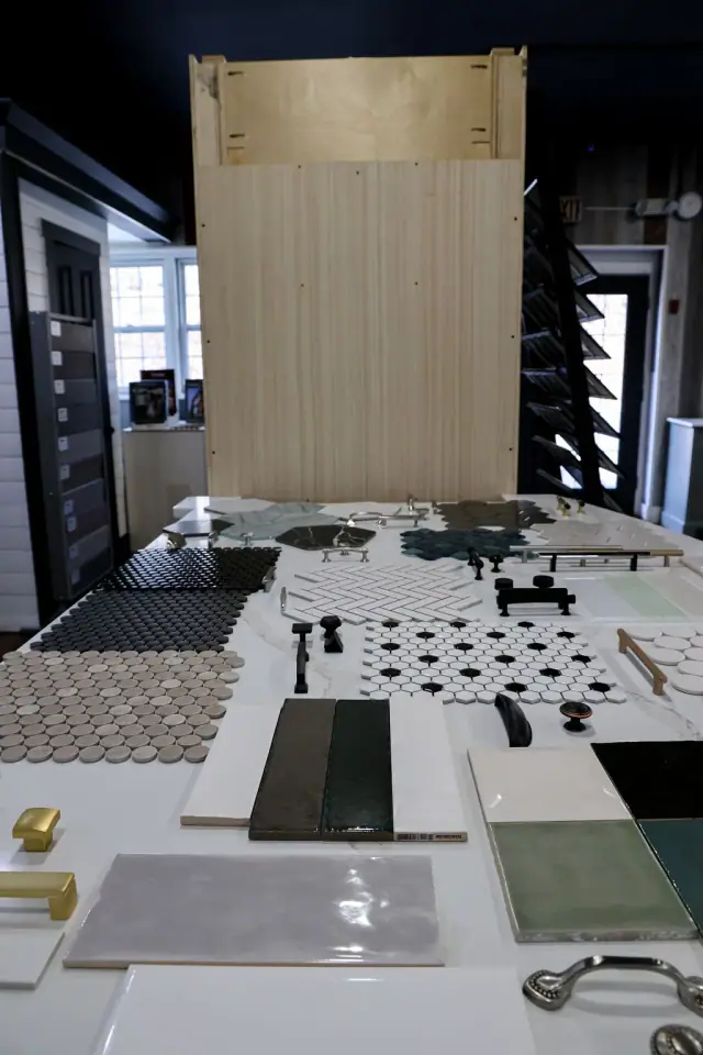 Black-and-white tile boards laid out near a dark cabinet