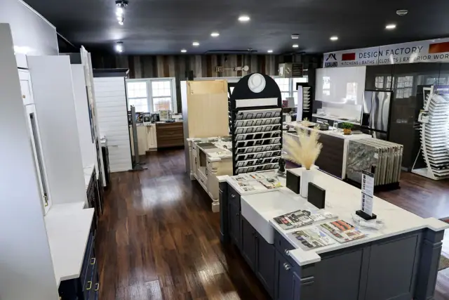 Long showroom aisle with islands and wood-look flooring