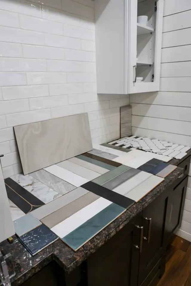 Mixed countertop samples arranged over a wood cabinet