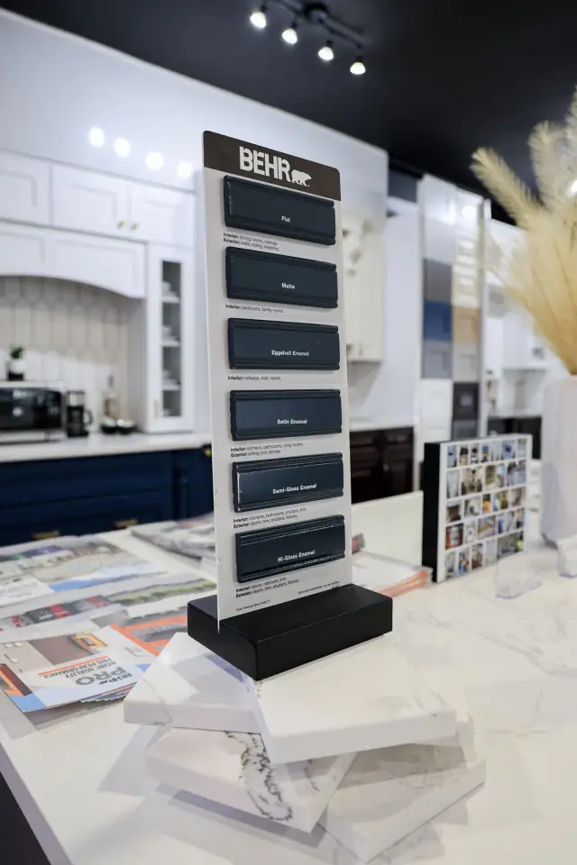 White media-style cabinet display with dark shelving
