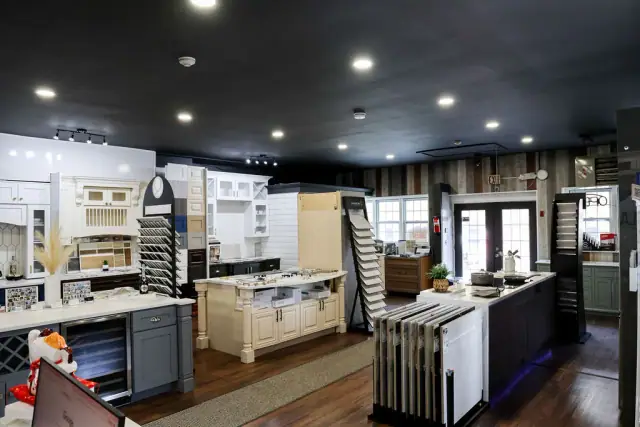 Wide showroom view with white islands and cabinet displays