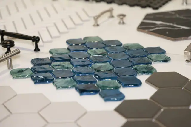 Blue geometric tile samples beside black fixture samples