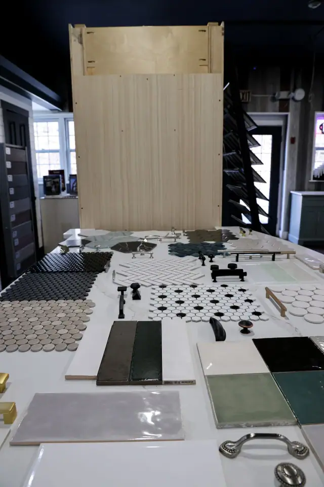 Black-and-white tile boards displayed beside dark cabinetry