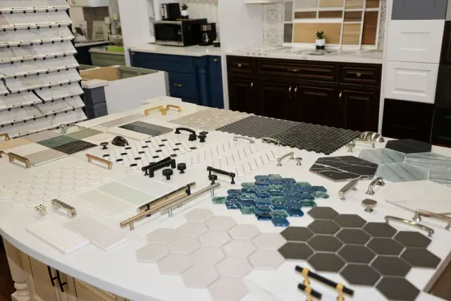 Material table with blue hex tile and cabinet samples