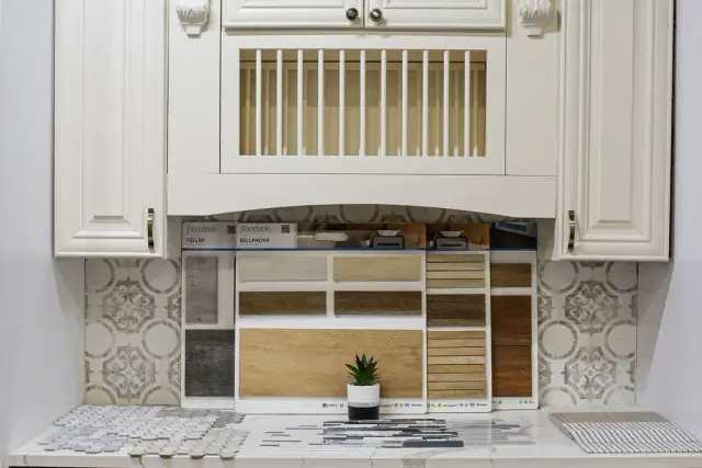 White cabinet display with gold grille doors and tile panels