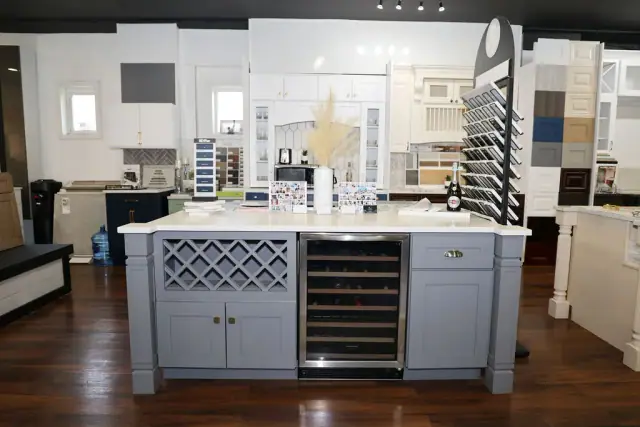 Front view of white island with wine storage and drawers