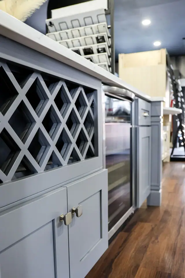 Blue-gray wine cabinet with countertop and open lattice storage