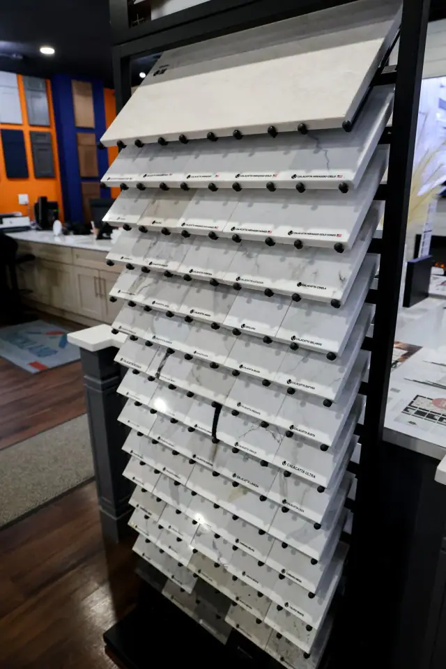 Tall rack densely filled with cabinet hardware samples