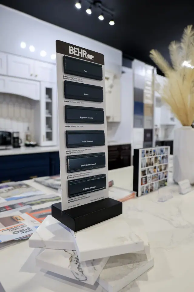 White shelving and dark feature wall in a cabinet display