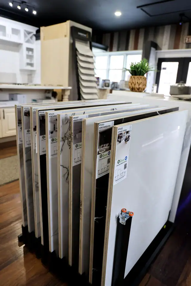 Tall cabinet door samples beside a light display island