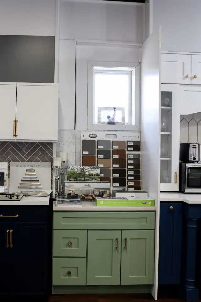 Green and blue base cabinet samples in a display row
