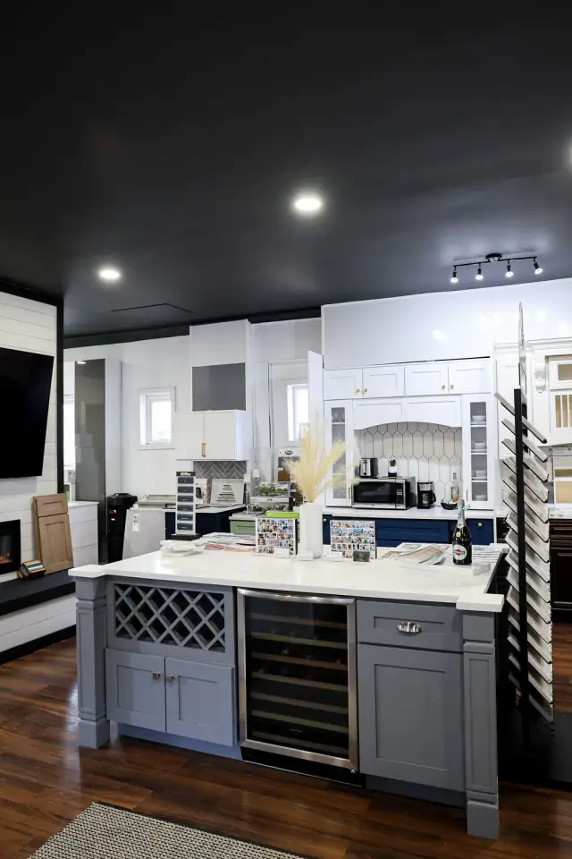 Blue-gray island display below recessed showroom lighting
