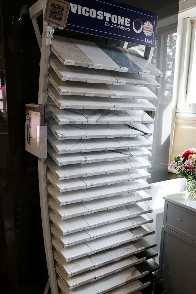 Tall cabinet finish sample rack beside a blue-gray display