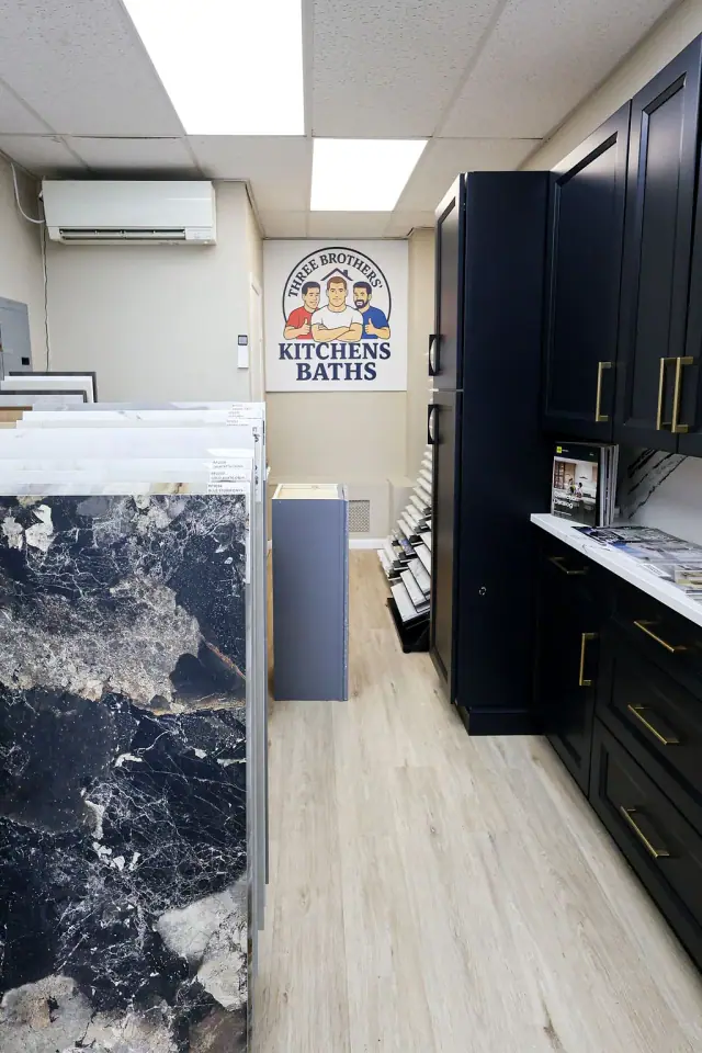 Black and white cabinet display beside a blue stone panel