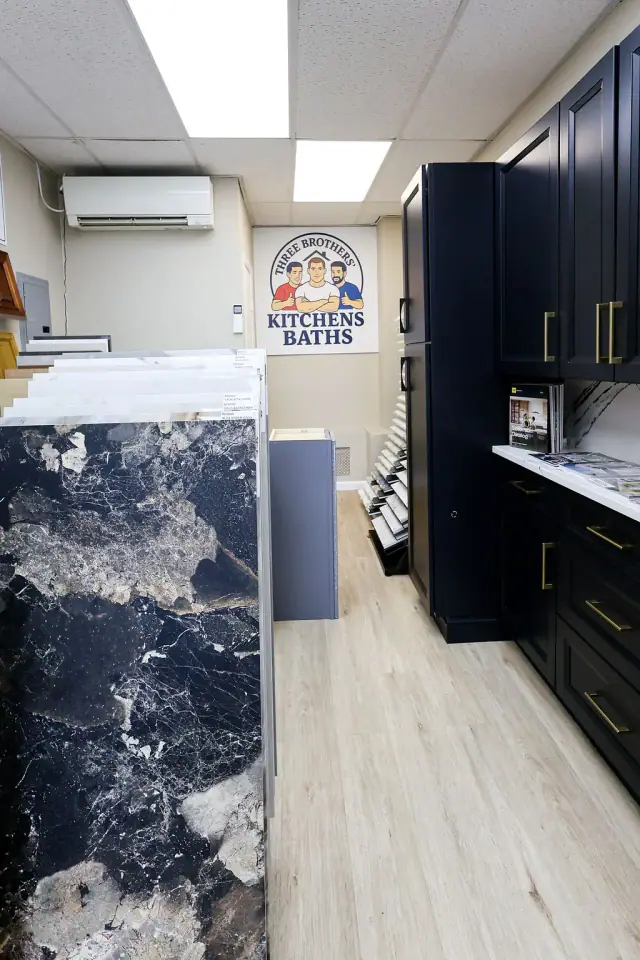 Black cabinet vignette beside a tall blue surface sample