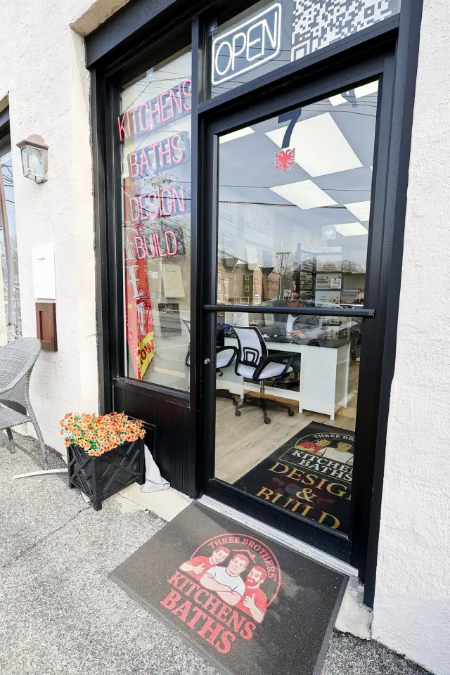 Tall black-framed showroom entrance and glass door