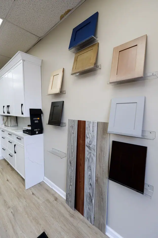 White cabinet display with wall-mounted finish samples