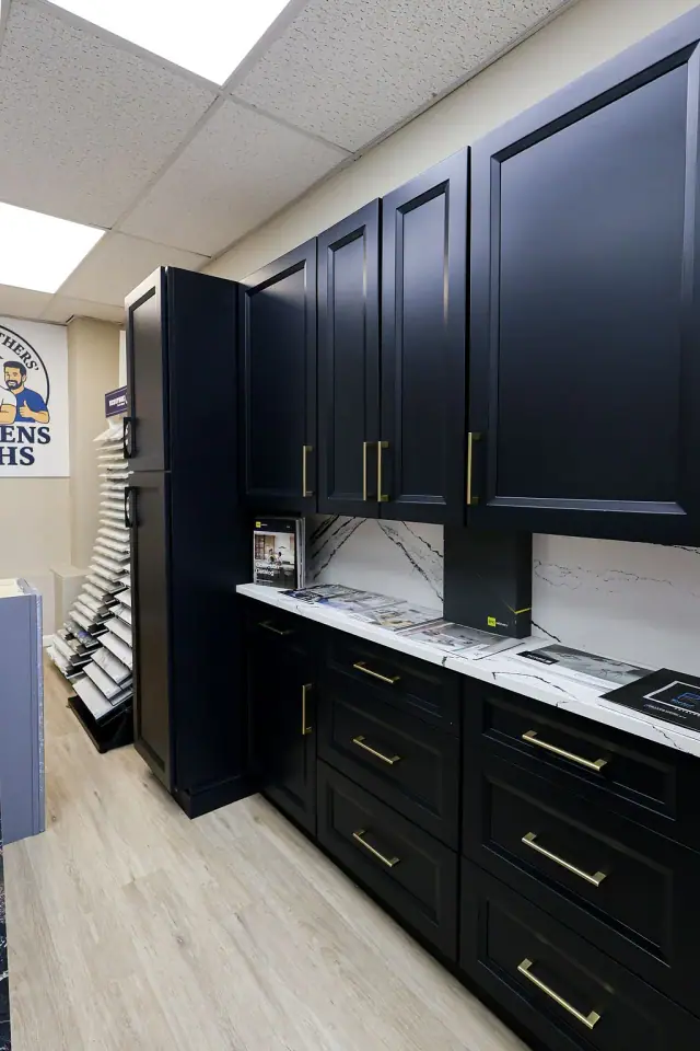 Black cabinet vignette with glass uppers and light countertop