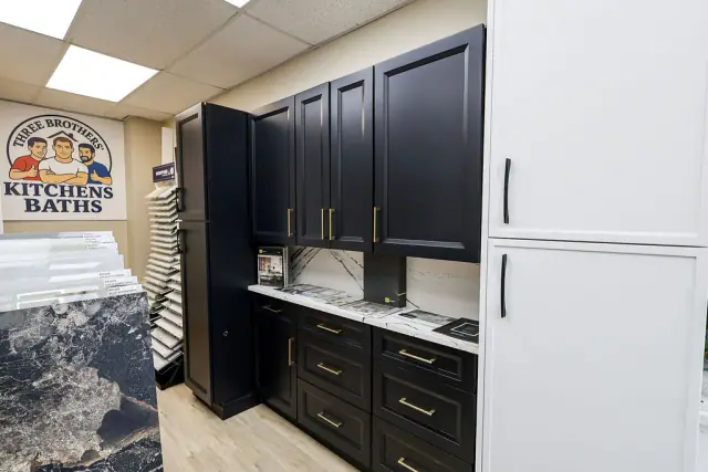 Dark cabinet display beside a blue stone-look panel