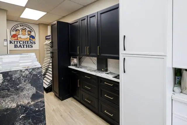 Black and white cabinet displays meeting at a showroom corner