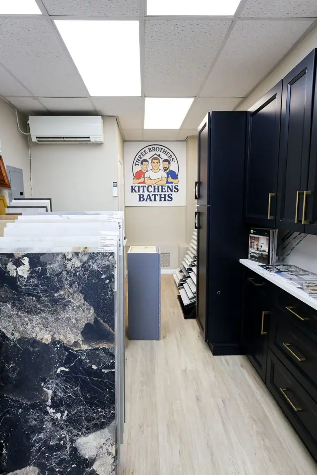 Blue stone panel beside a dark cabinet showroom vignette